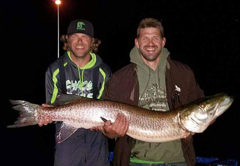 Two men holding a large muskie while fishing on Lake Vermilion