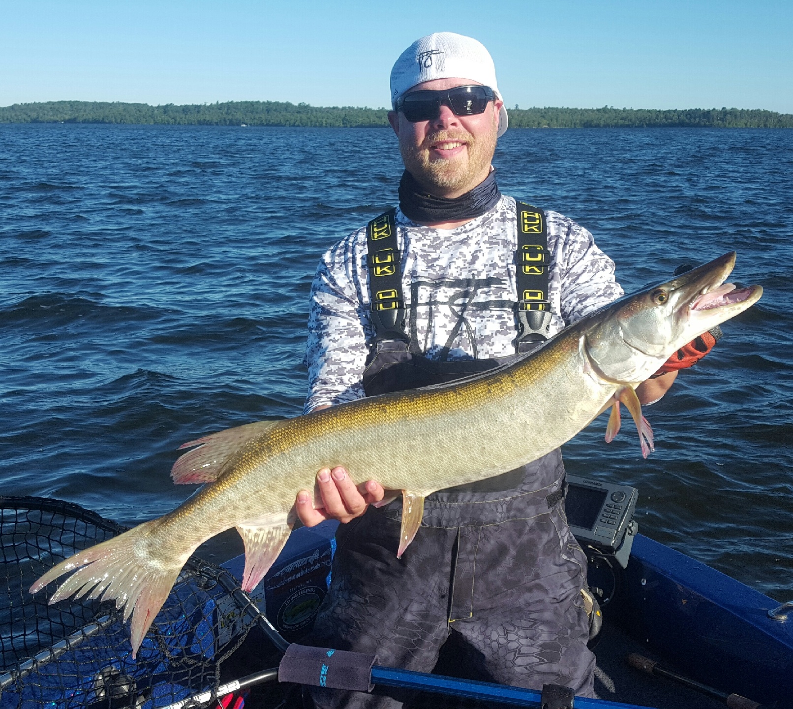 Guy holding a trophy size muskie while fishing with the best Minnesota Muskie guides