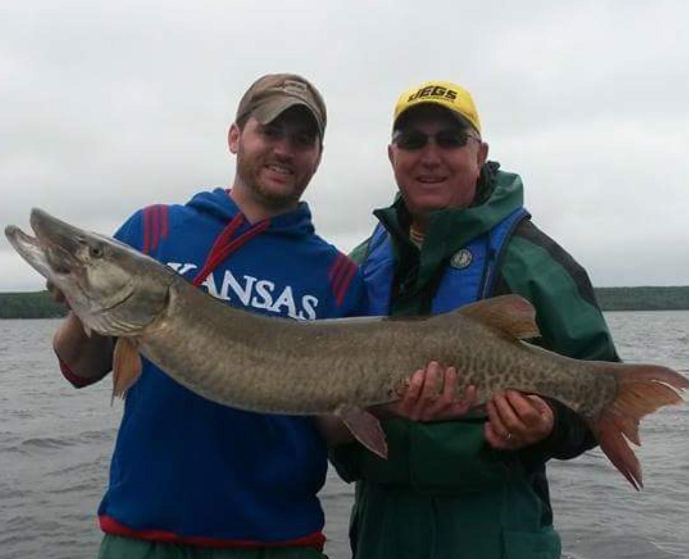 Two guys holding a trophy size muskie that they caught with Living Legends Guide Service